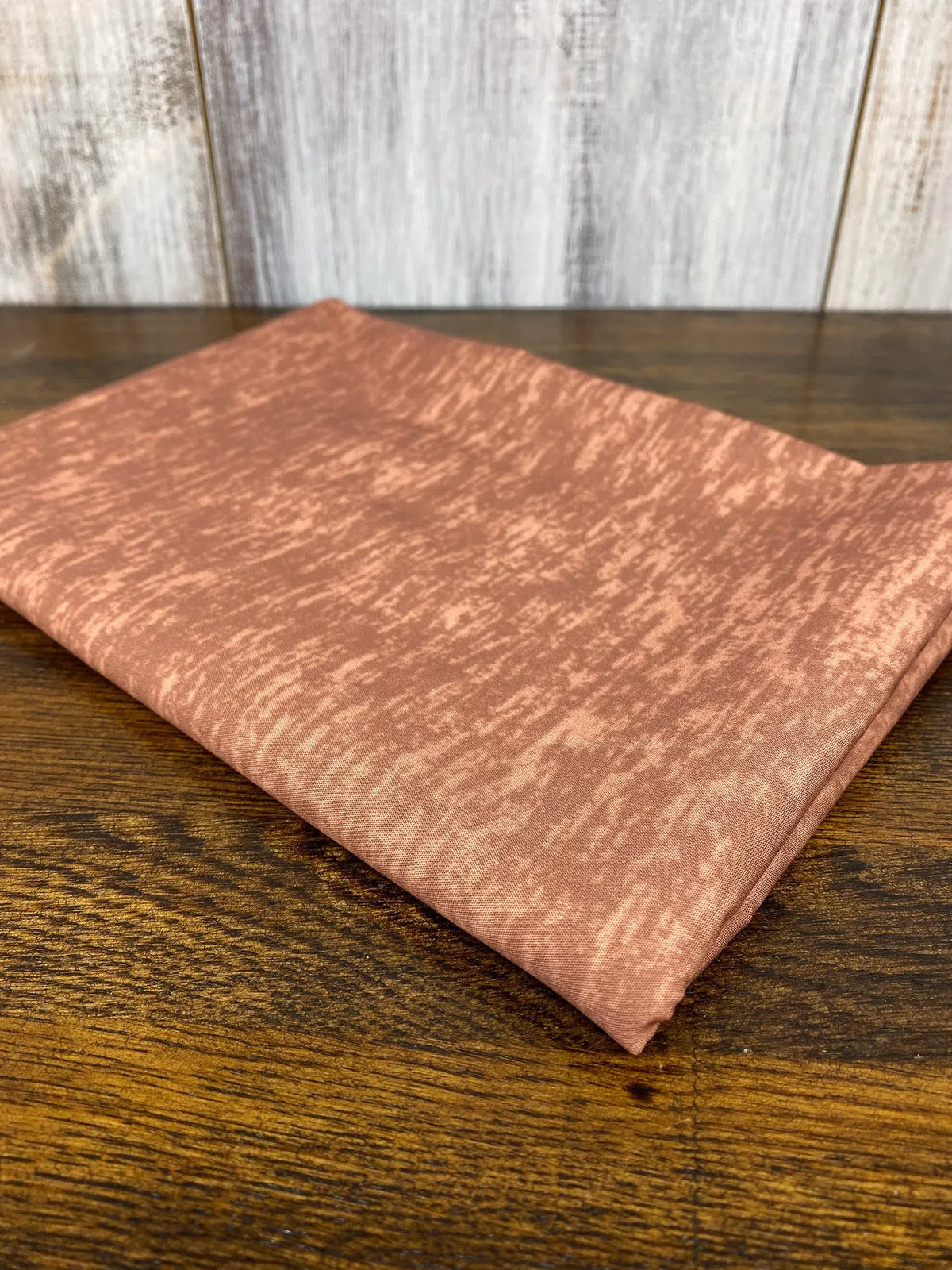 Folded Pumpkin Heather fabric with a subtle textured pattern.