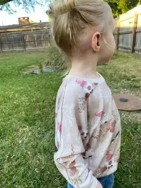 Tan gnome toile fabric in autumn holiday print on a light beige base.