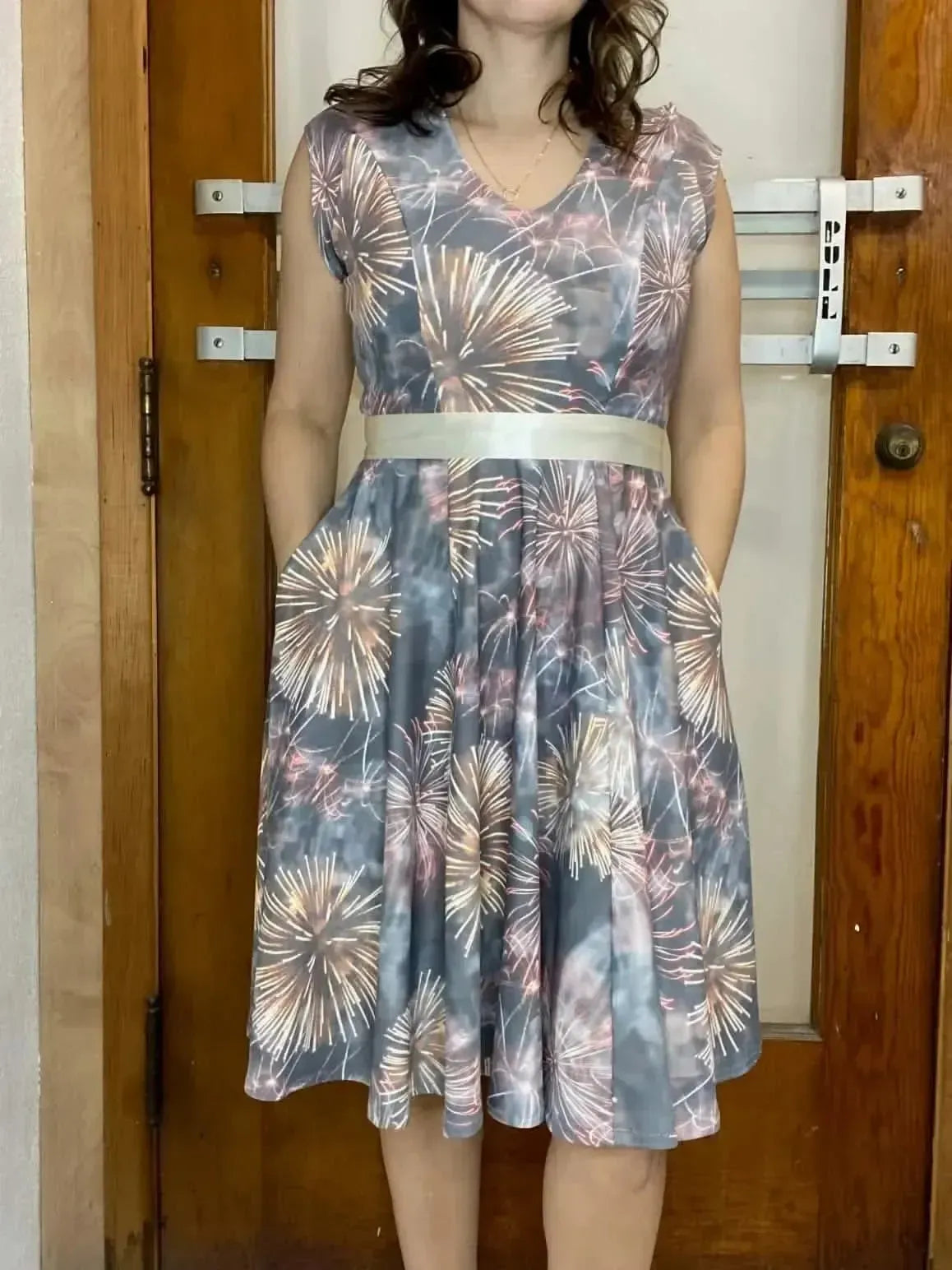 Close-up of Celebration Fireworks Print Fabric showing festive gray and pink fireworks pattern.