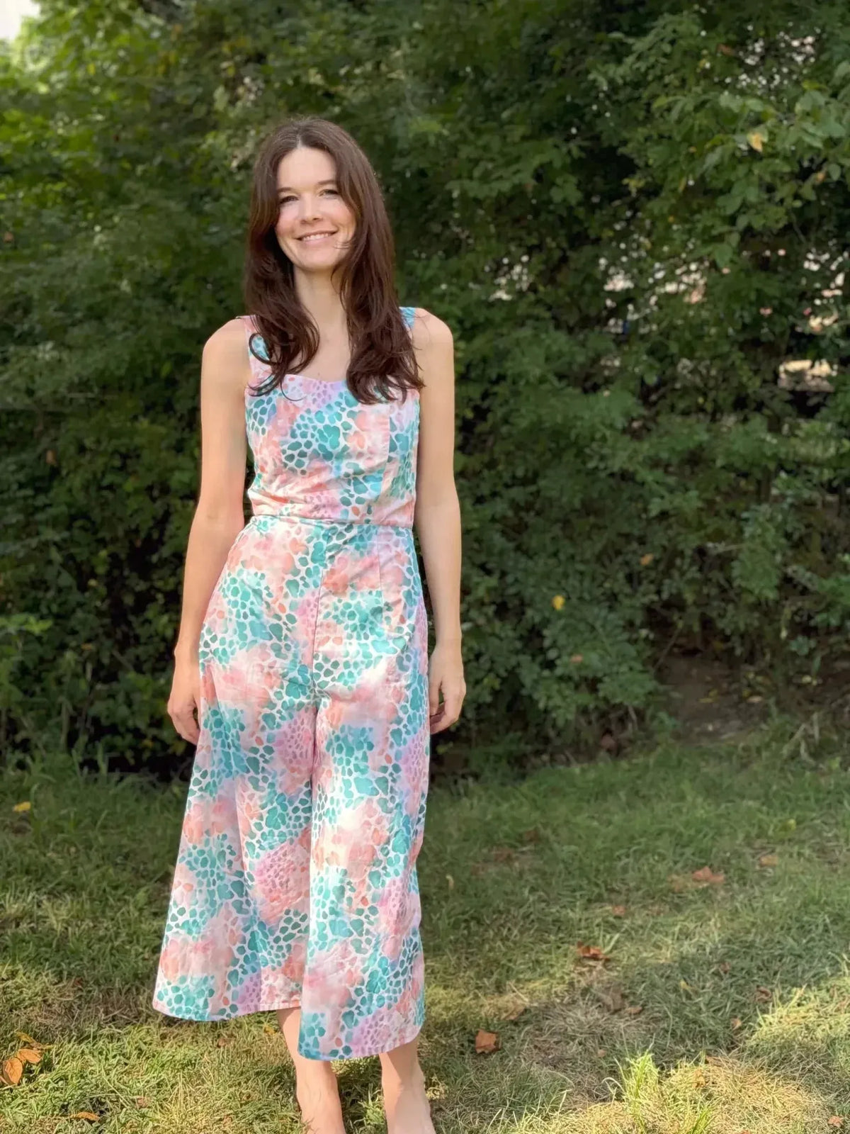 Vibrant abstract print fabric with wild heart patterns in pink and teal hues.