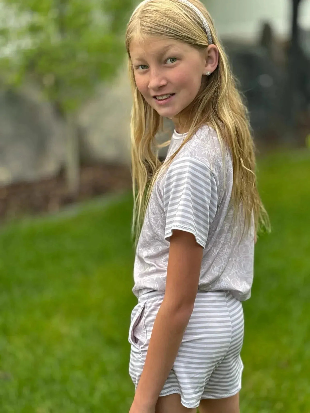 Tan stenciled floral print fabric from WayMaker Fabrics, shown in a sewn garment.