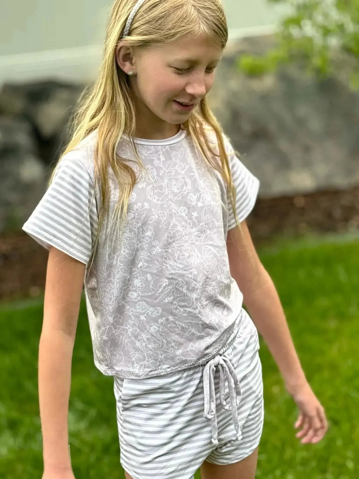 Tan stenciled floral print fabric in light beige with subtle white floral patterns.