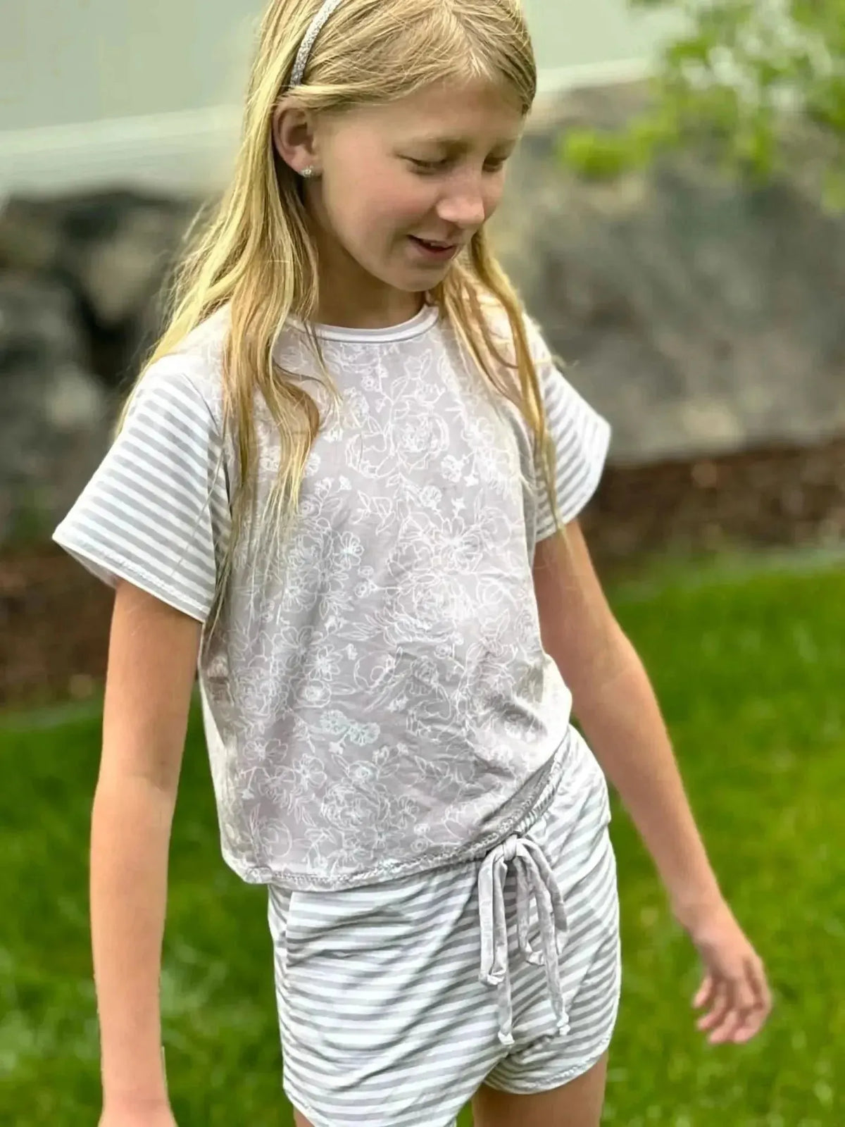 Tan stenciled floral print fabric in light beige with white floral motifs.