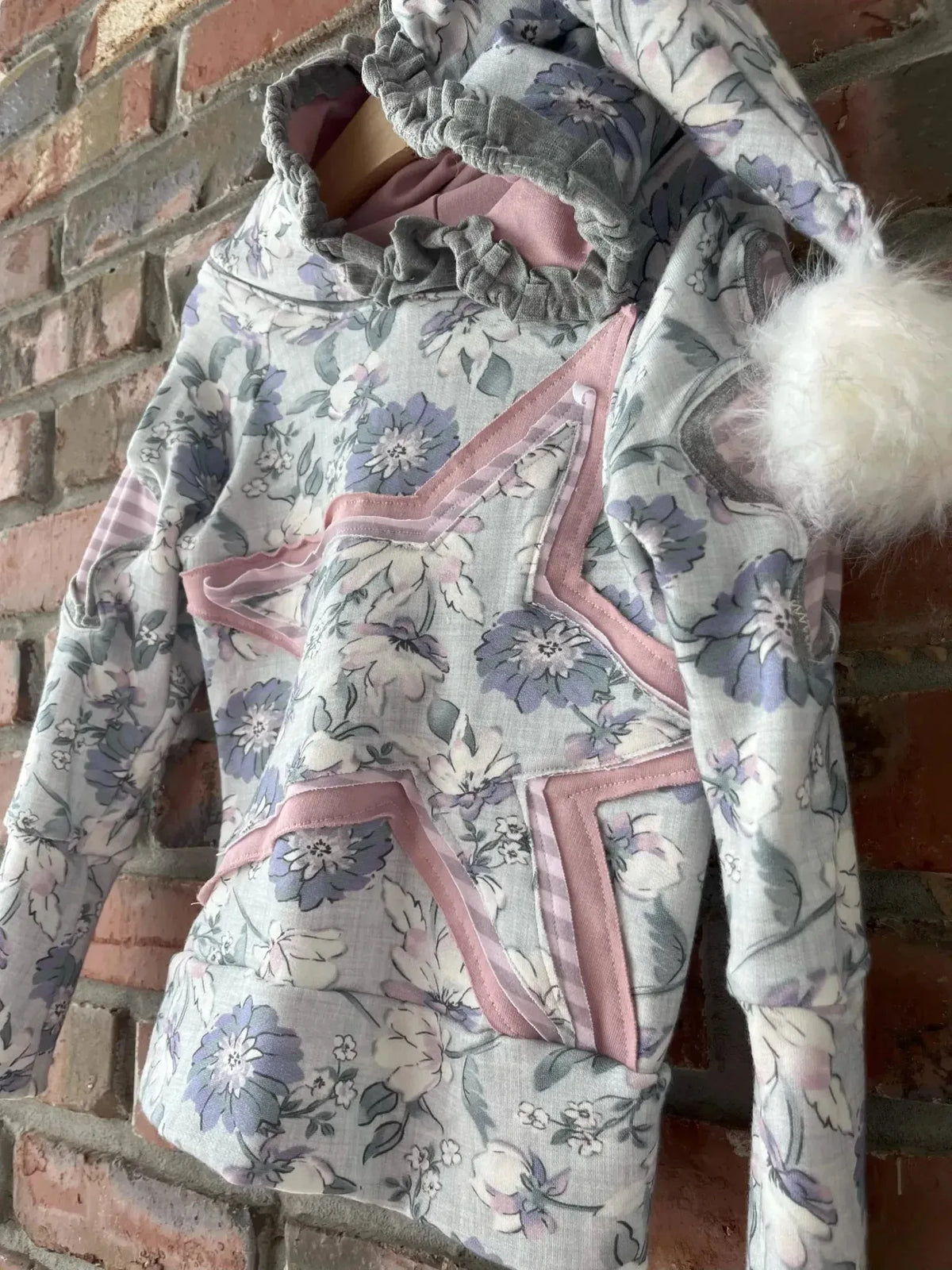 Purple floral print fabric with cornflower meadow pattern in soft tones.