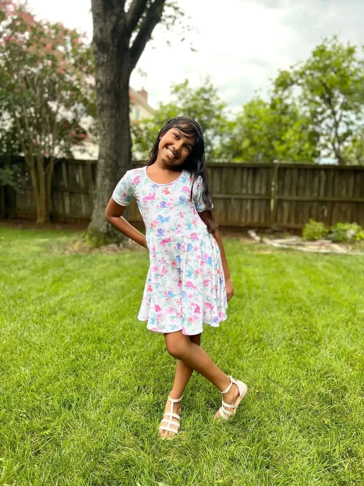 Blossom-o-saurus floral dinosaur print fabric with pink flowers and green dinos.