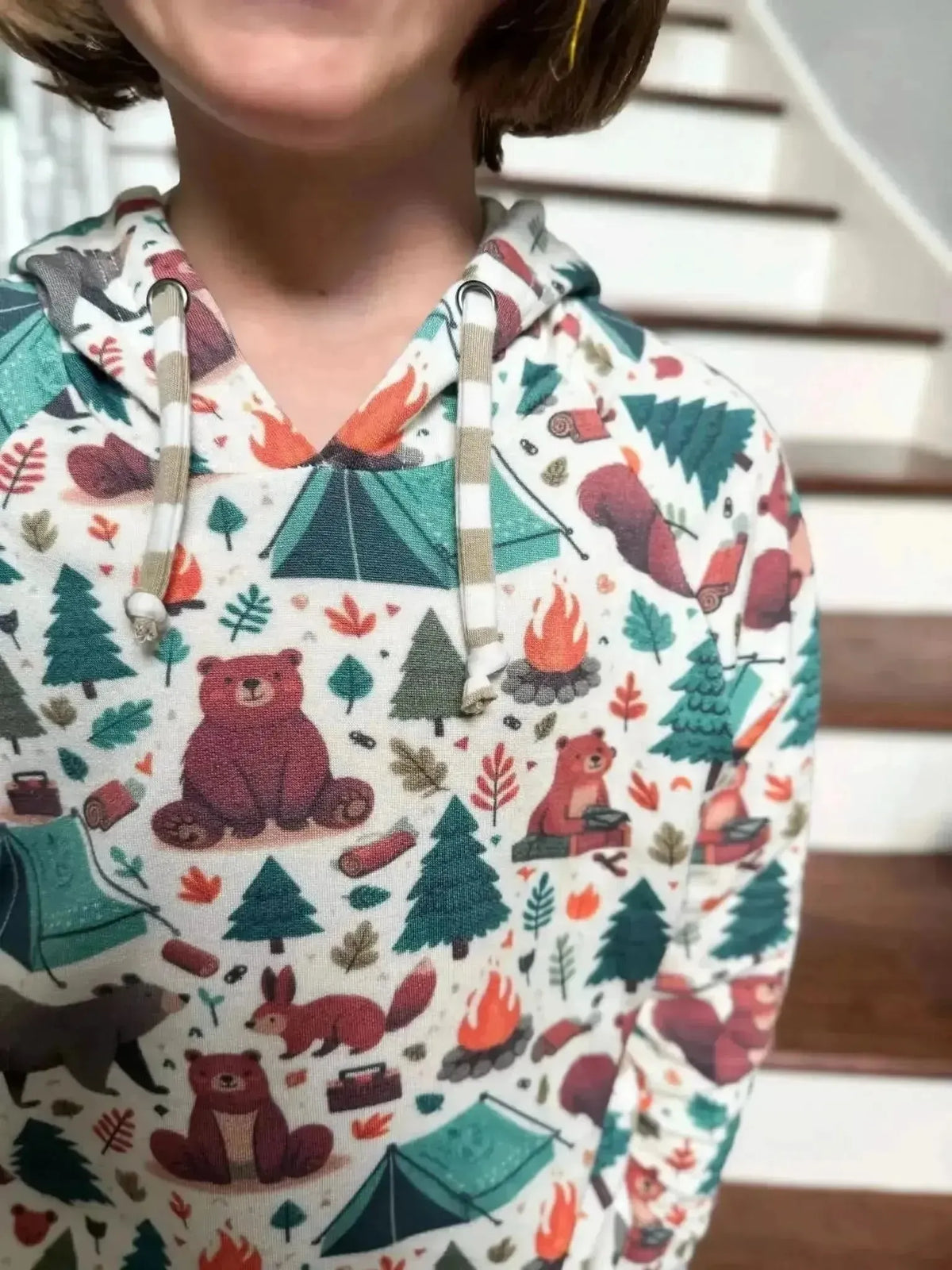 Fabric with woodland camping print featuring bears, tents, trees, and animals.