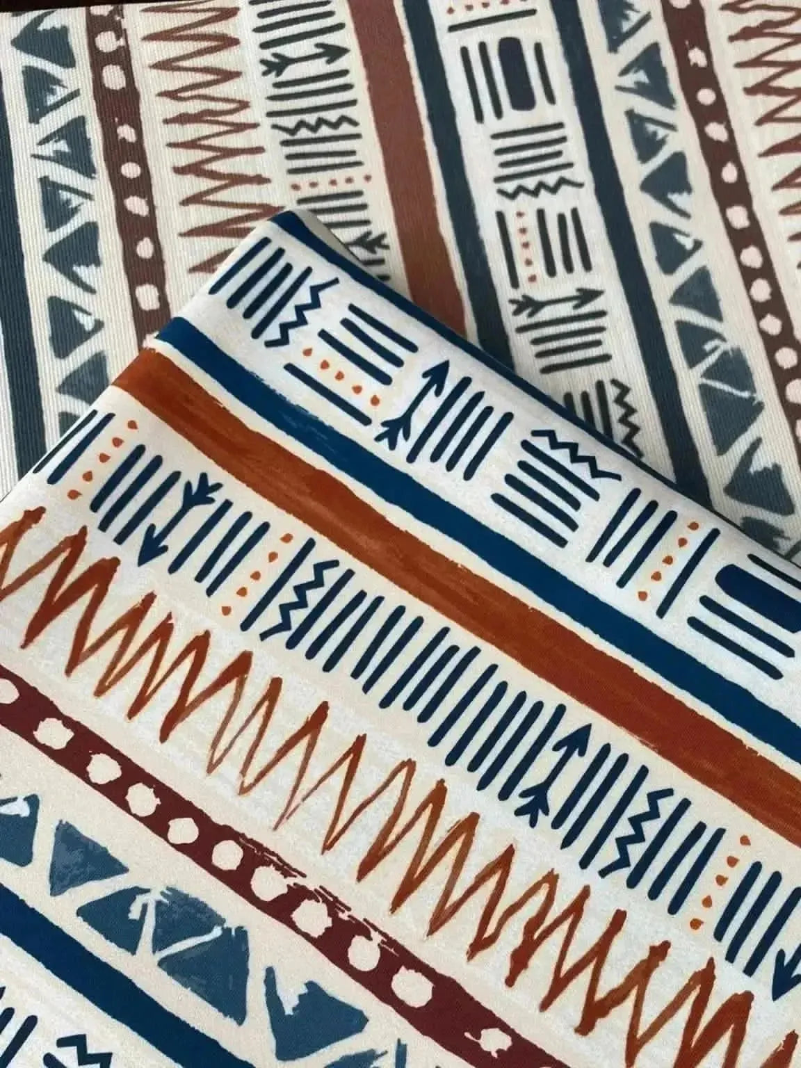 Desert Echoes Faith-Based fabric with geometric arrow and line patterns in navy, rust, and cream.