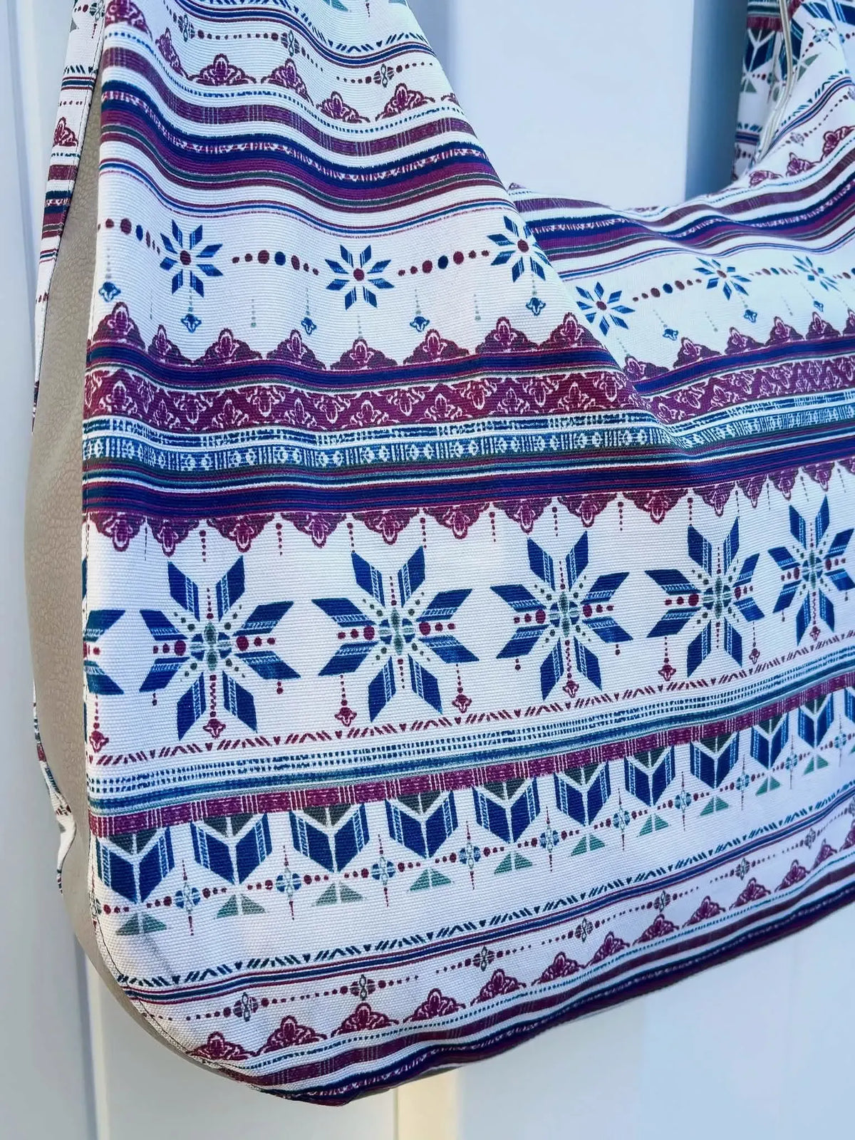 Frosted fabric with blue, purple, and white geometric patterns.