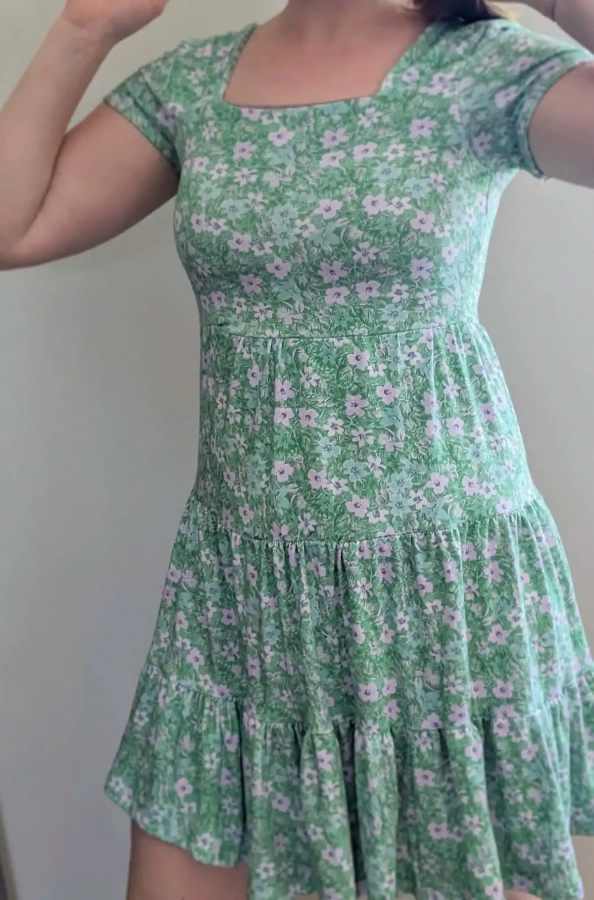 Green dress with light purple and blue floral pattern.