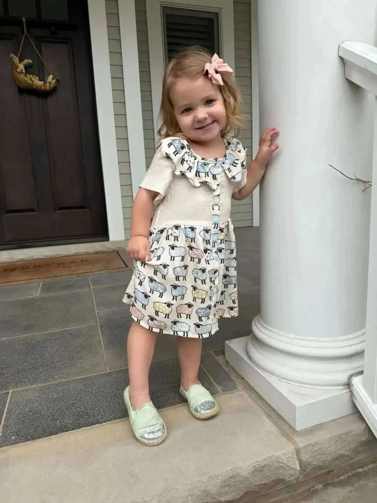 Patchwork sheep print craft fabric with white, black, and gray animal motifs.