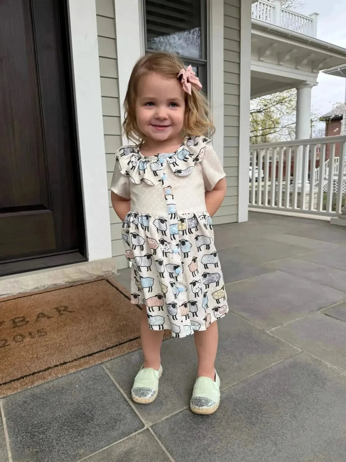 Patchwork sheep print craft fabric with white and black animal motifs.