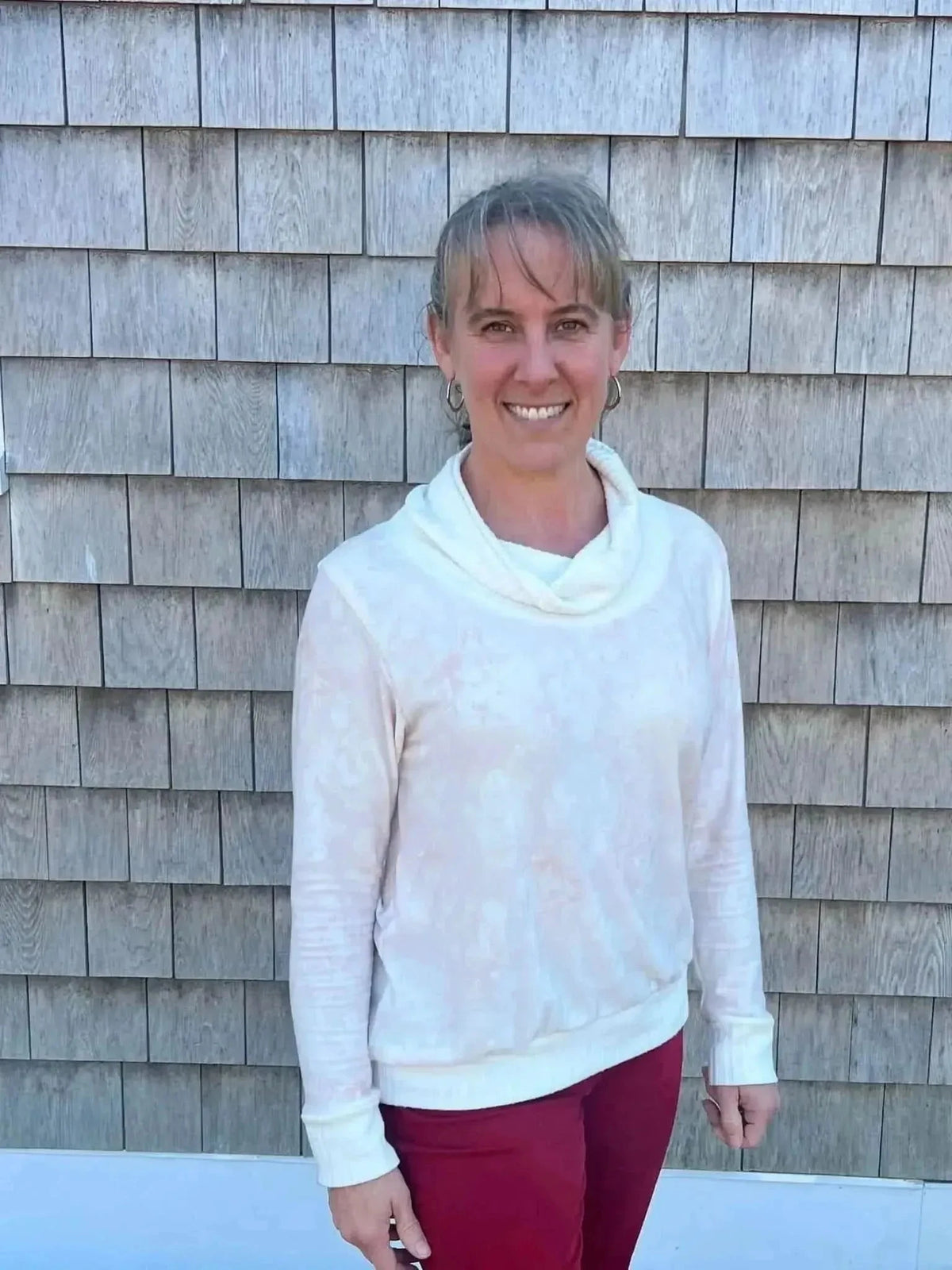 Close-up of elegant pink floral print fabric on a light background.