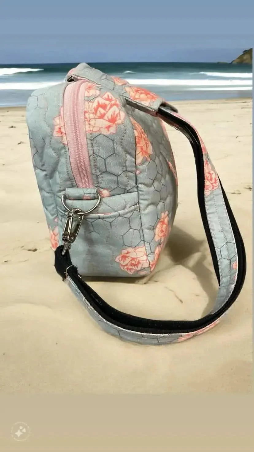 Honeycomb floral fabric with nature-inspired pink flower print on gray background.