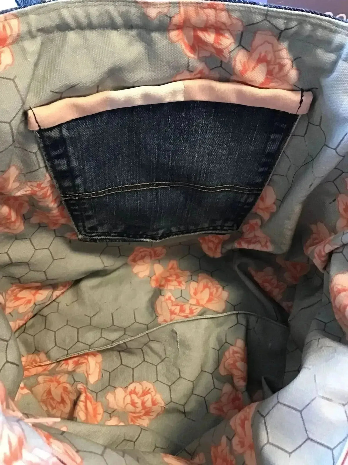 Honeycomb floral fabric with gray honeycomb pattern and orange flowers.