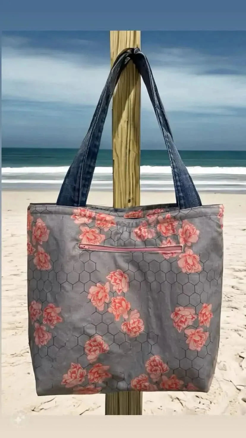Gray honeycomb fabric with pink floral print, nature-inspired design.