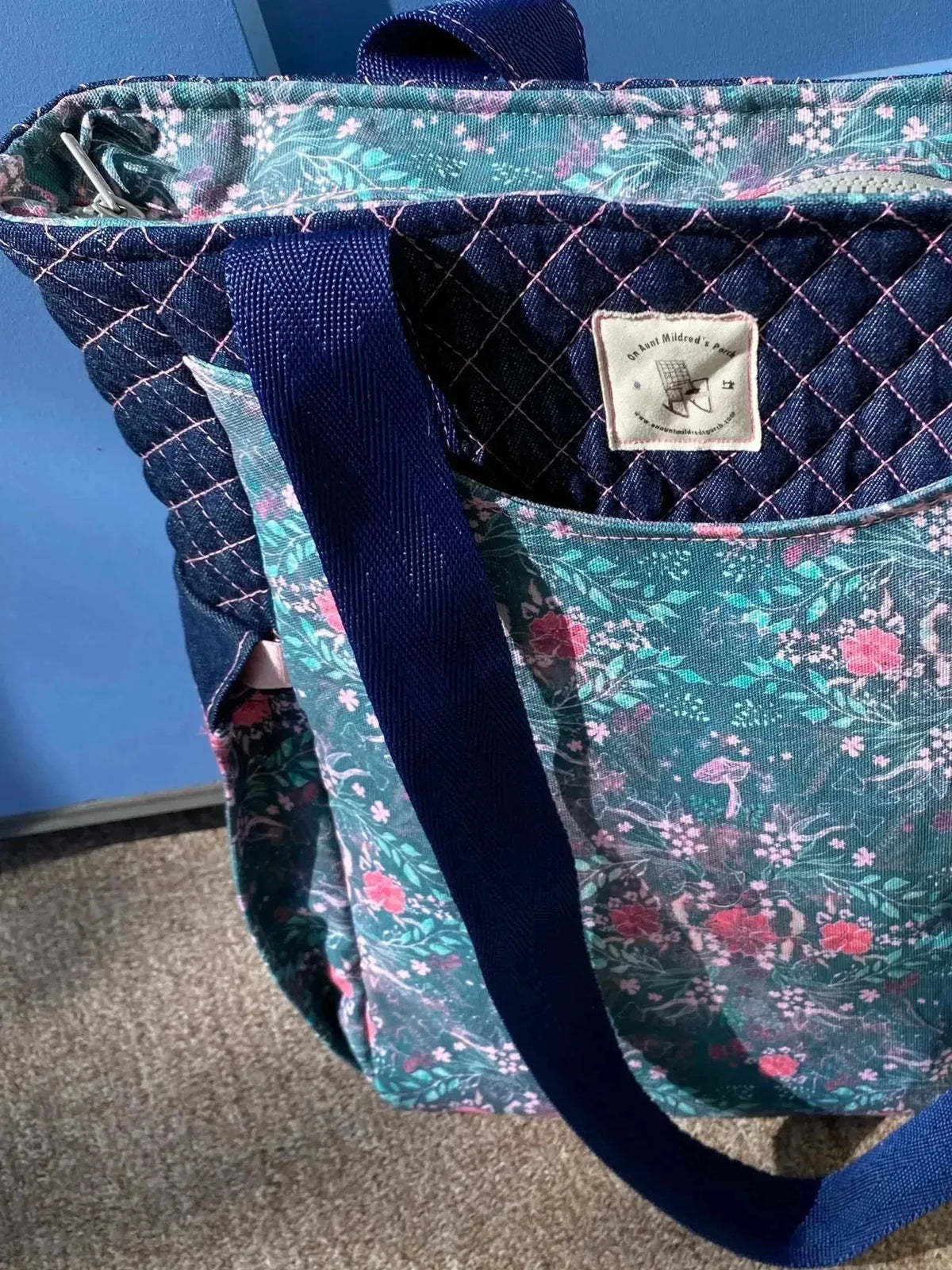 Dark teal floral botanical print fabric with enchanted meadow pattern.