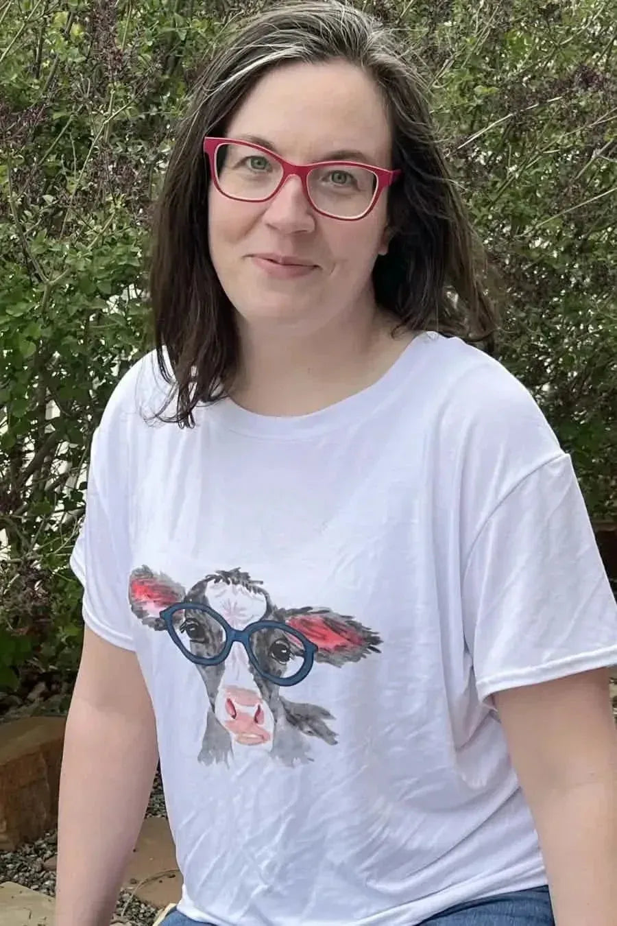 Panel of novelty fabric featuring a cute cow print with red glasses.
