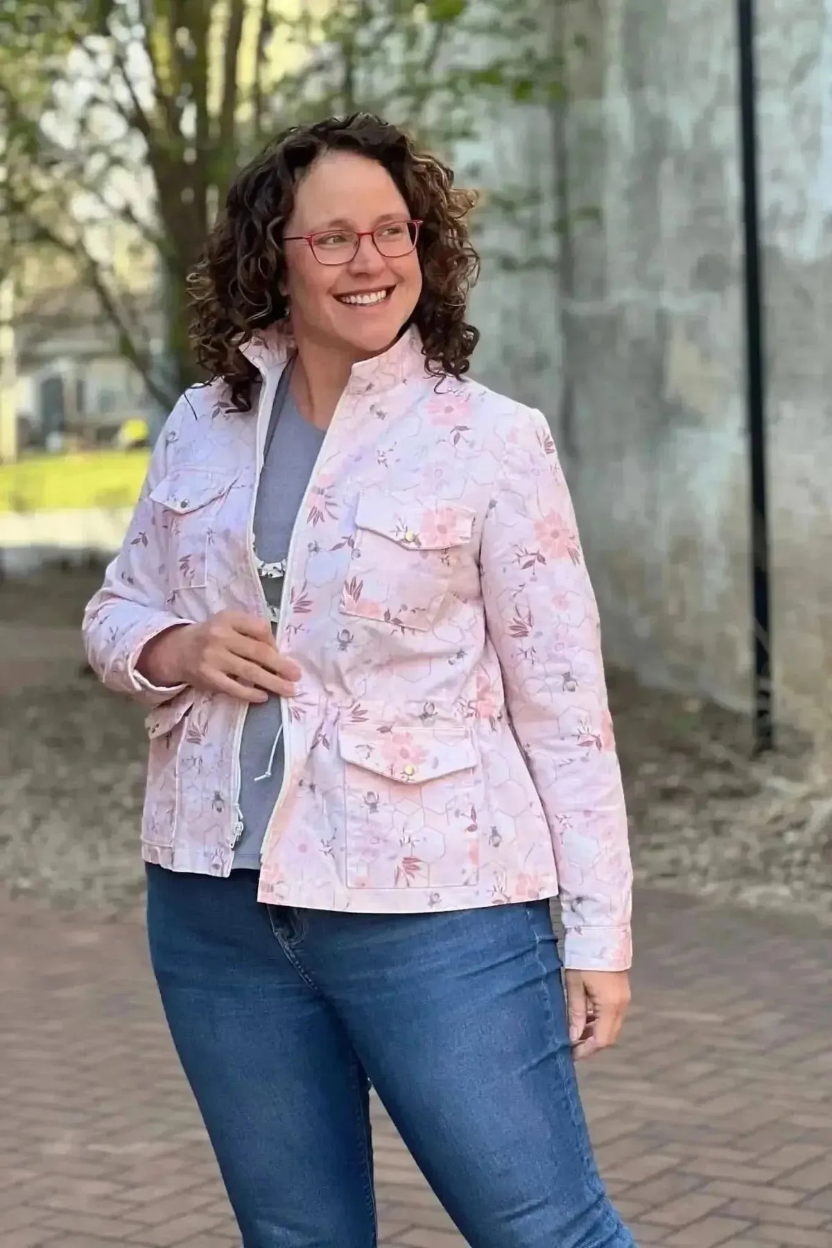 Peach fabric with garden bee print, shown in a pink utility jacket on a model.