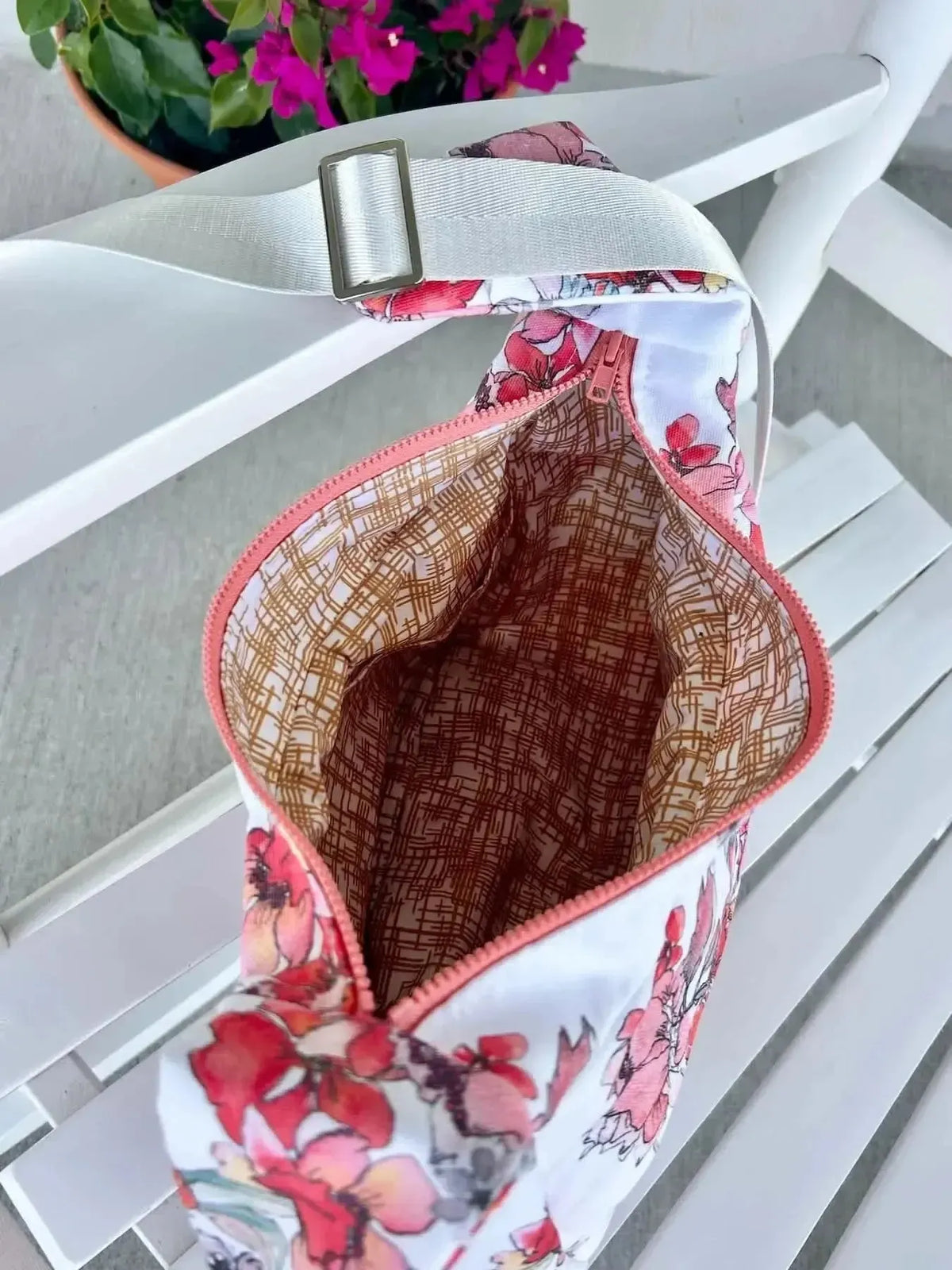 Gold Hatch floral print fabric with pink and red flowers on a white background.