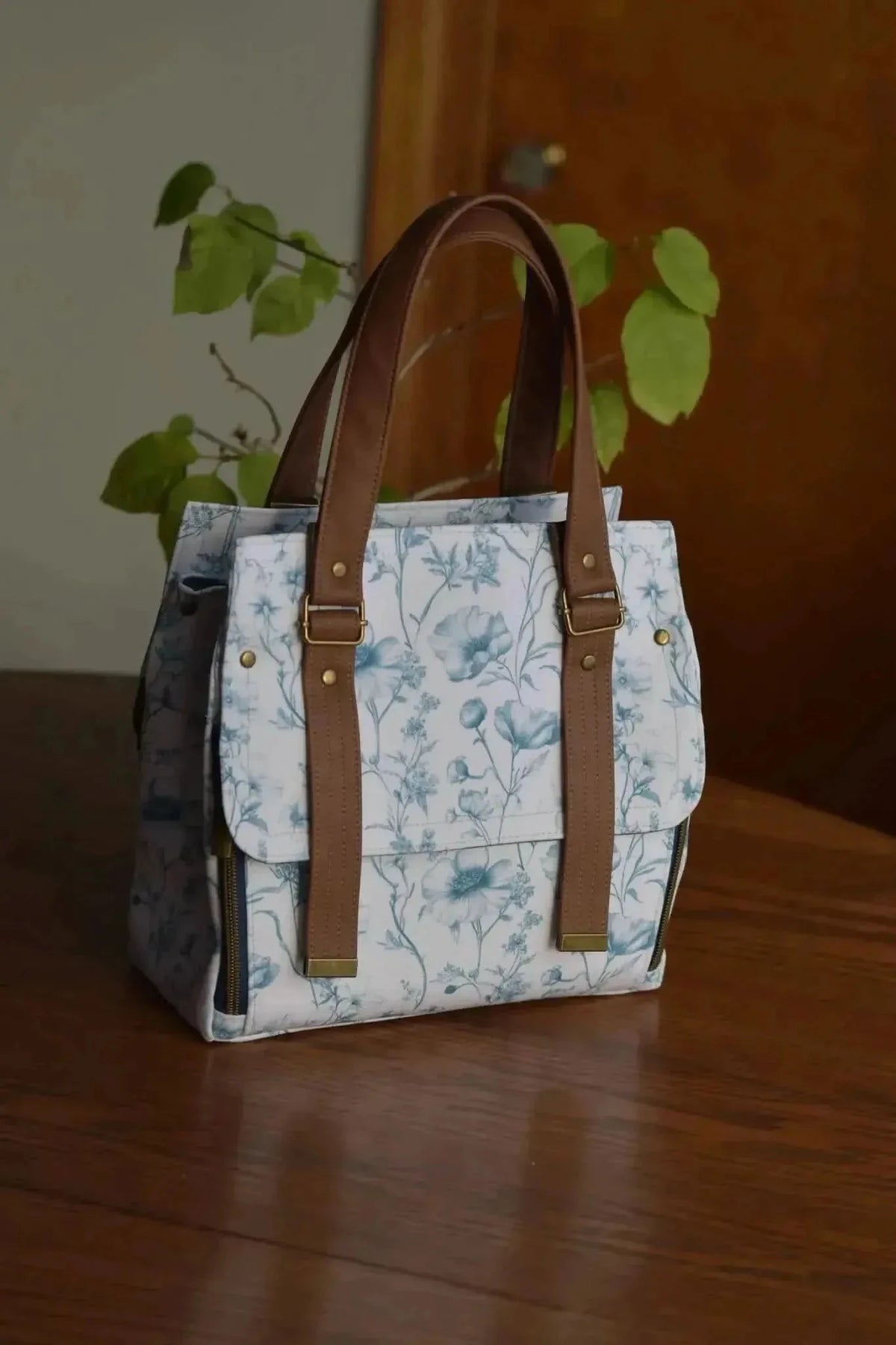 Blue garden symphony botanical print fabric with white background, birds, and flowers.