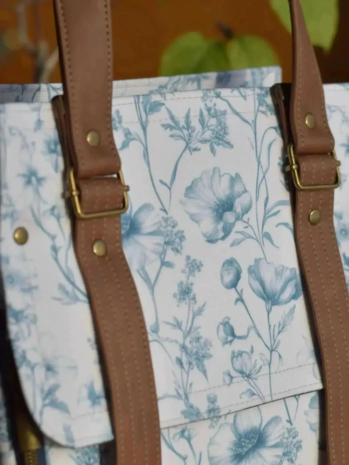 Blue garden symphony botanical print fabric featuring white flowers and leaves on a light blue background.