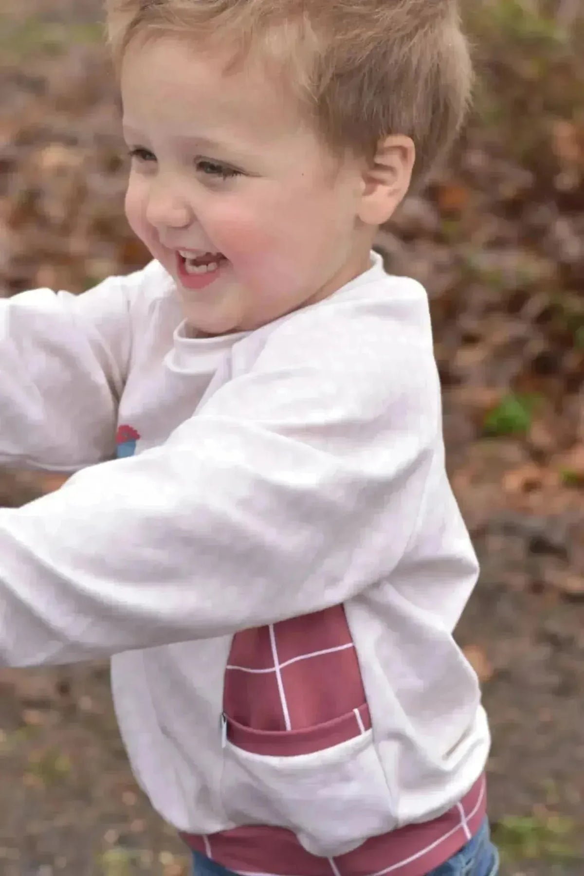 Red windowpane pattern fabric with plaid design in cotton and stretch blends.
