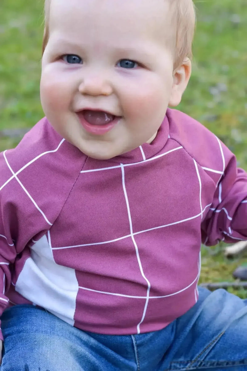 Red windowpane pattern fabric with purple and white checkered design.