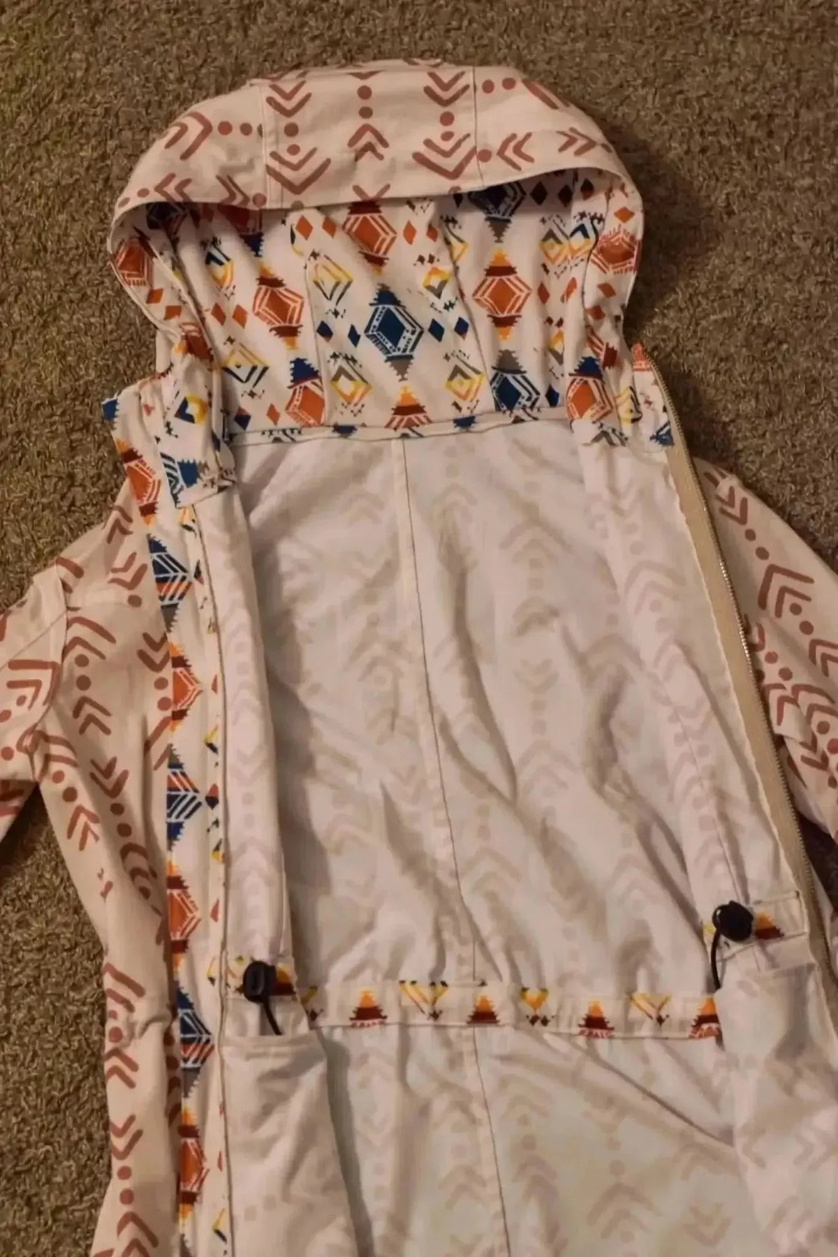 White fabric with orange and blue Southwestern diamond print pattern.