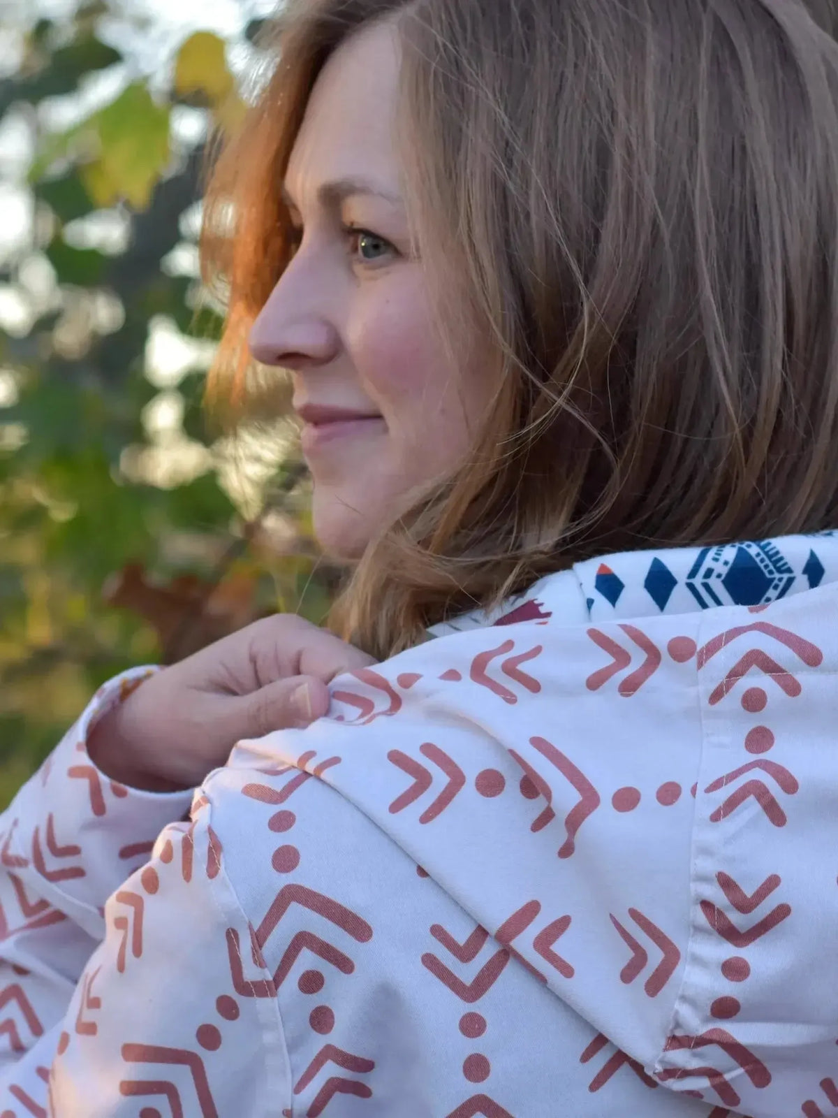 Terracotta abstract echoed steps fabric with geometric patterns on a white base.