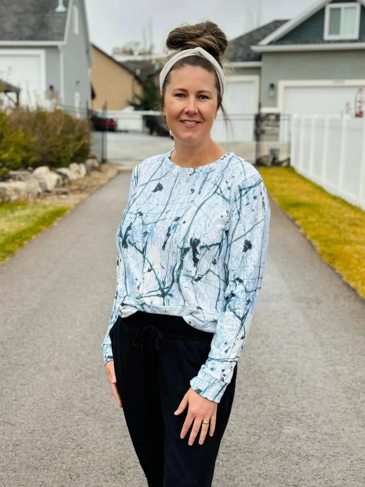 A woman wears a long-sleeved shirt with a white and blue cracked ice pattern.