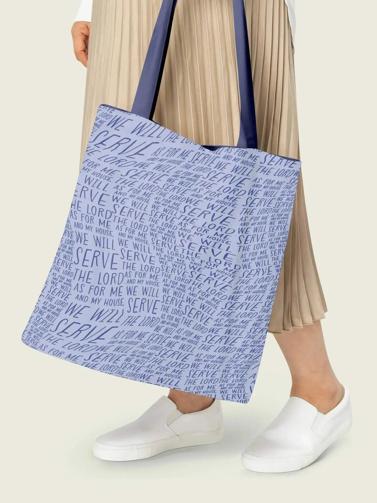 A light blue fabric tote bag with "WE WILL SERVE THE LORD" text.