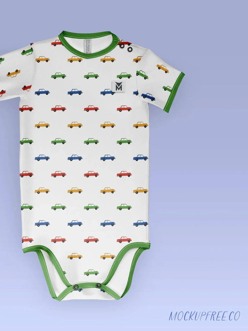 A white baby onesie with a colorful car pattern and green trim.