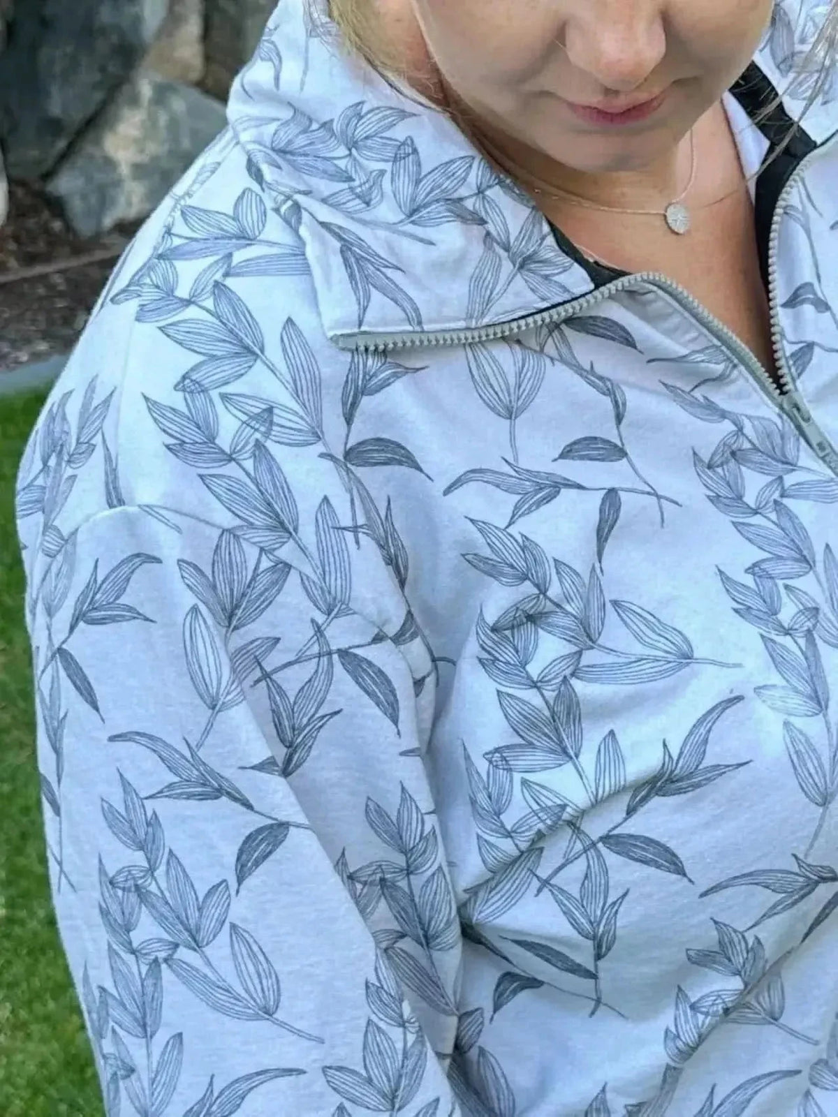 Grey foliage botanical fabric with white leaf print on light grey background.