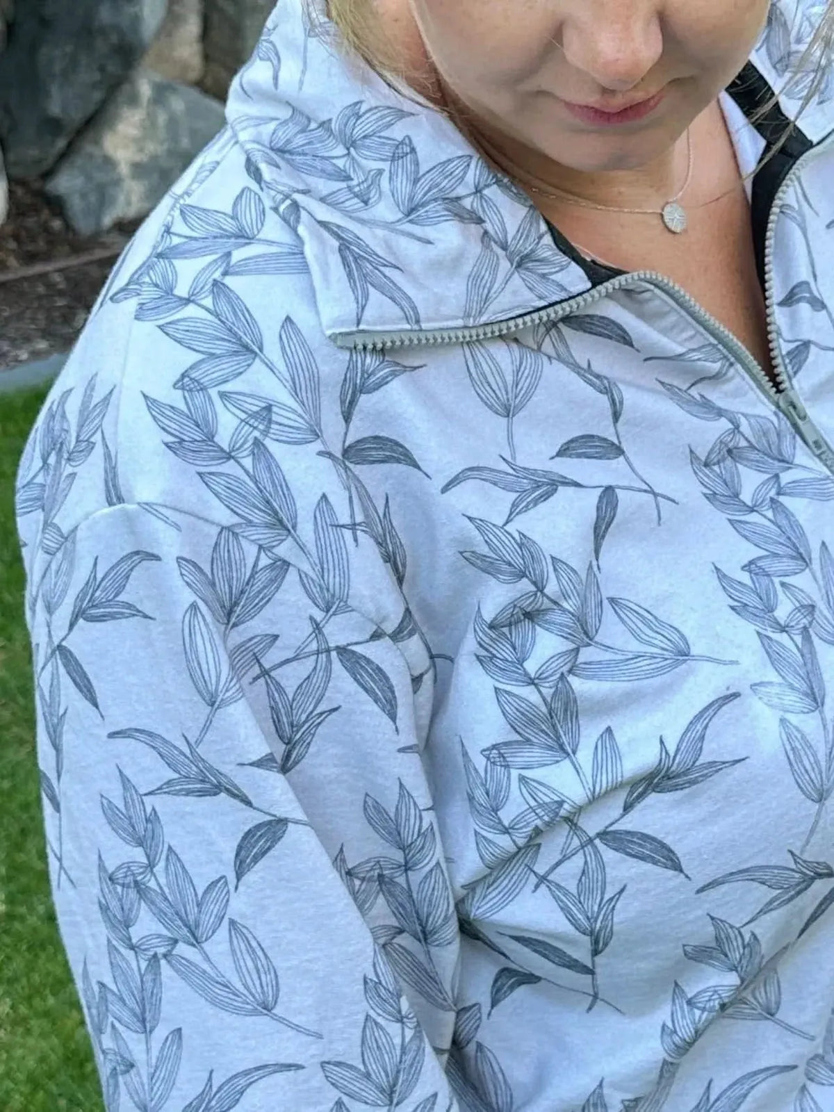 Grey foliage botanical fabric with white leaf print on light grey background.