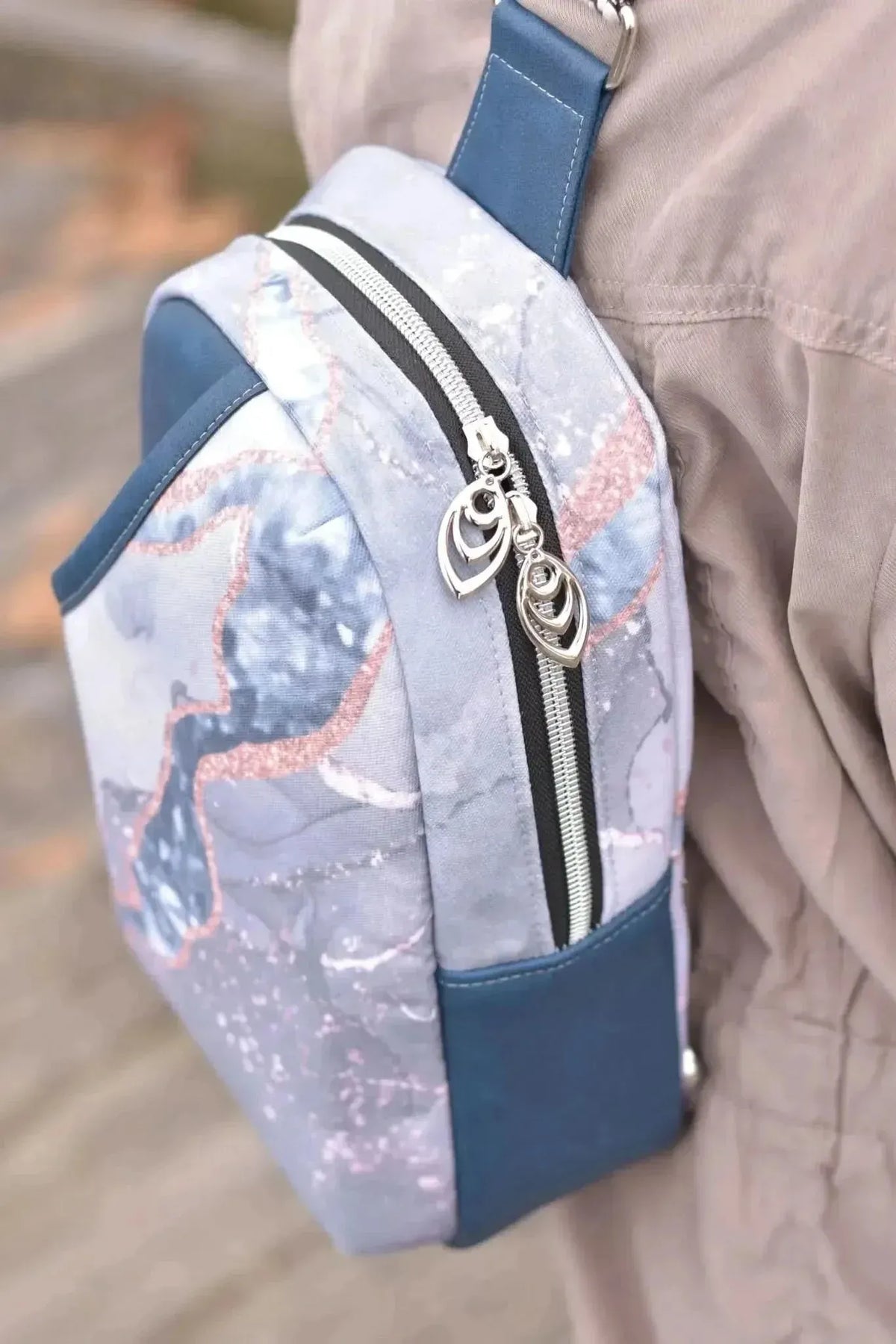 A small bag made from blue marble pattern fabric with a solid blue base.