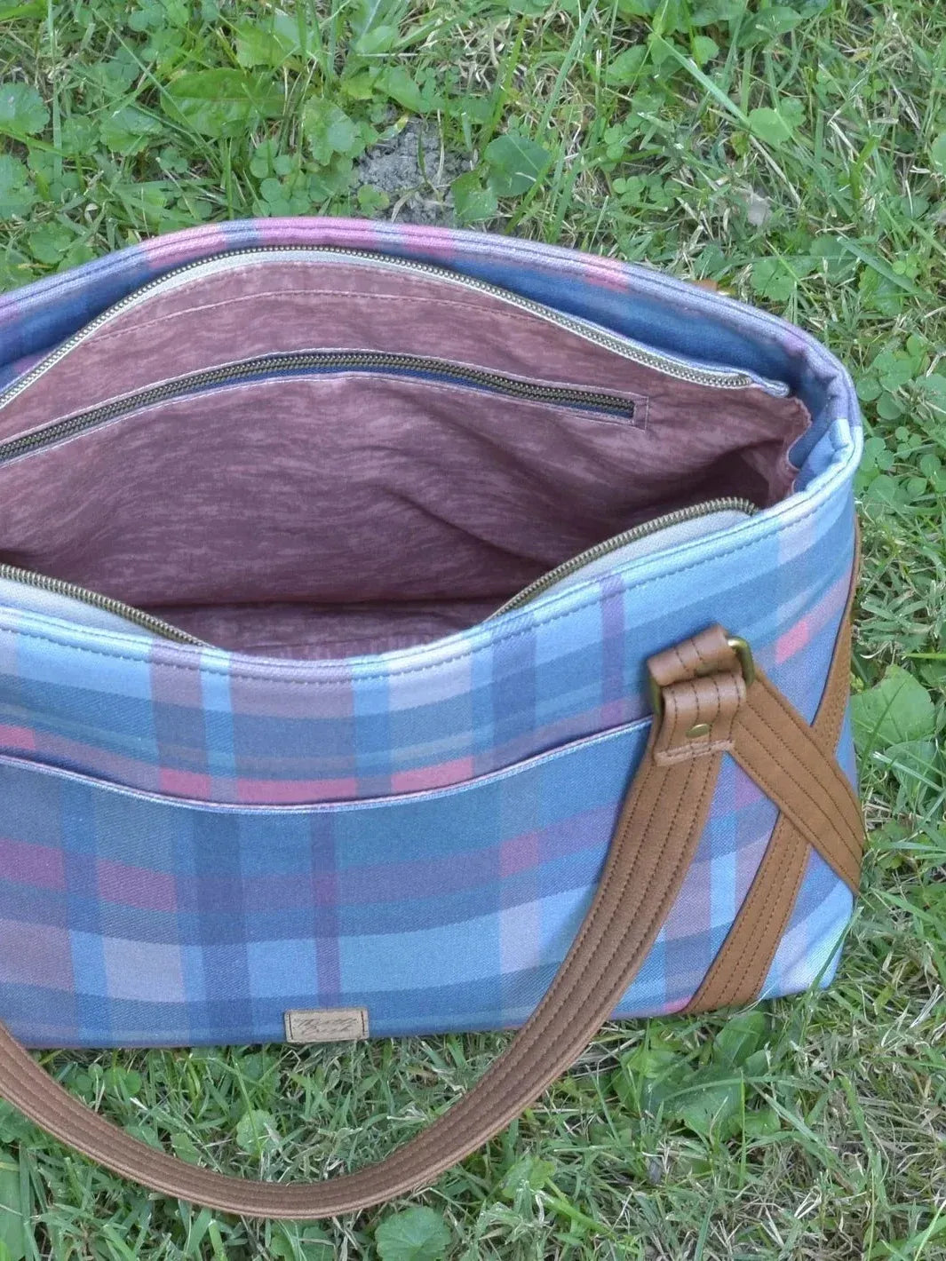 Fall teal plaid fabric print with blue, pink, and white checkered pattern.