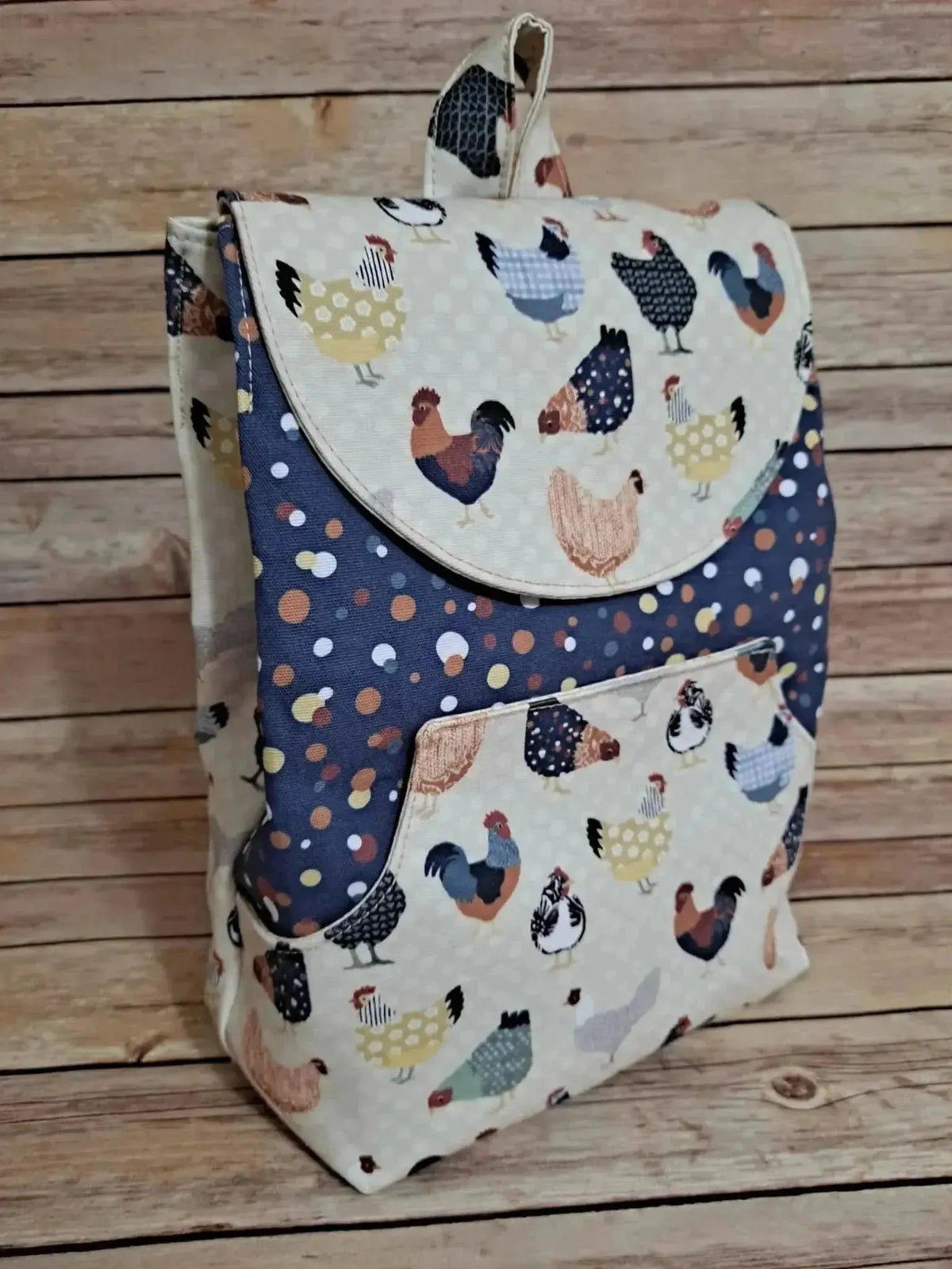 Patchwork fabric featuring a colorful print of various chickens on a light background.