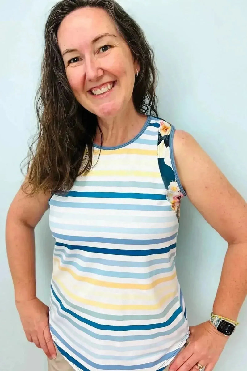 Blue and white striped fabric with nautical floral accents on a light background.