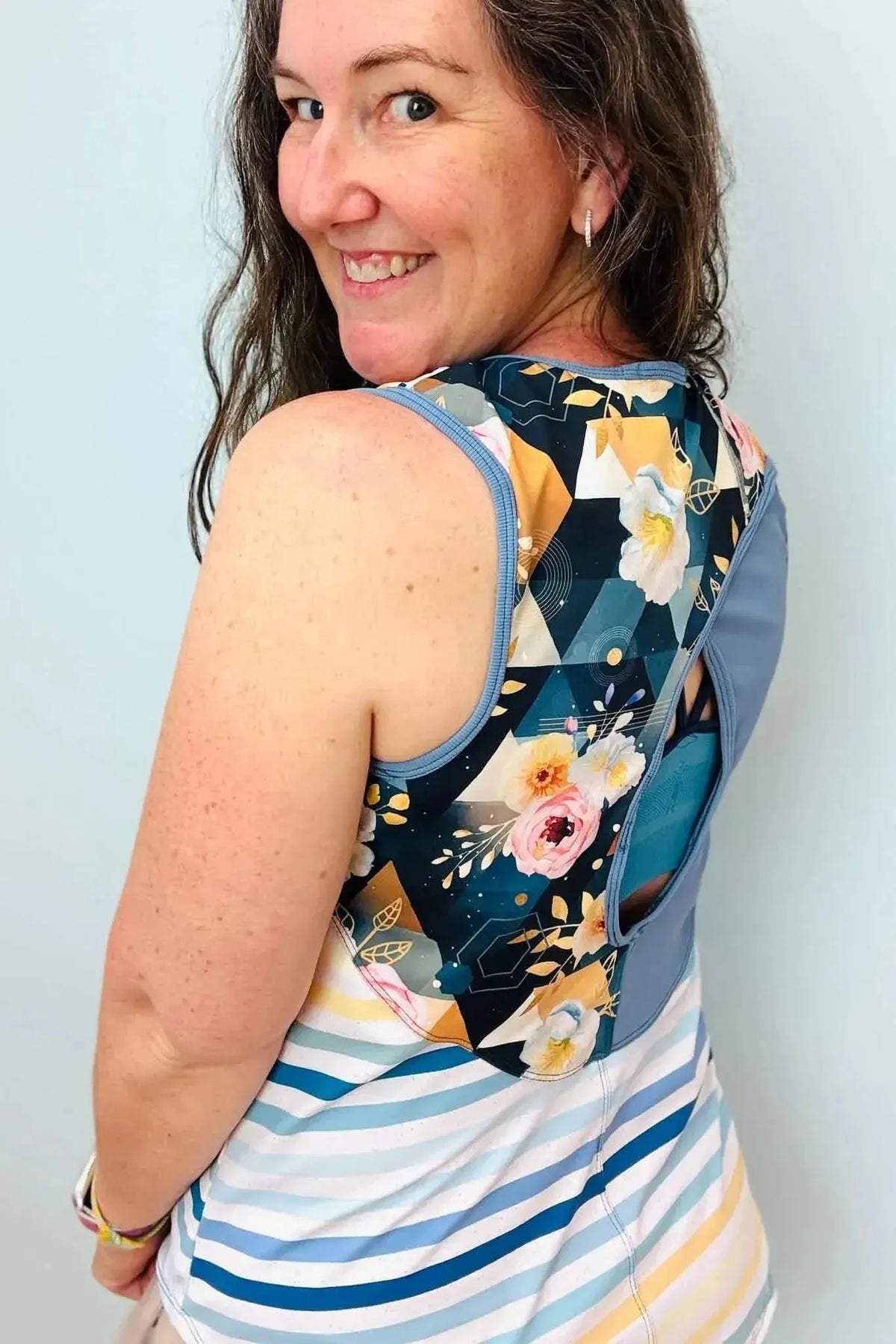 Blue and white striped Seaside fabric with geometric and floral patterns.