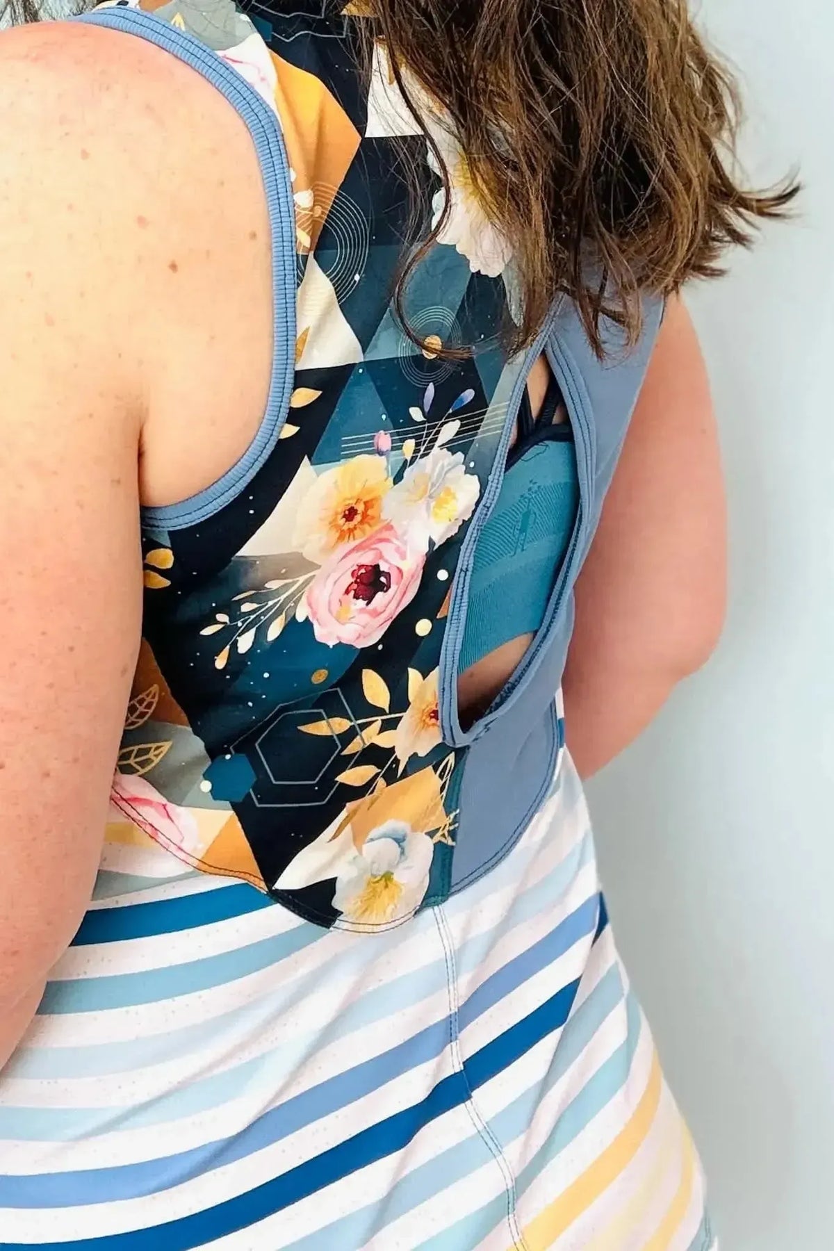 Blue and white striped seaside fabric with subtle floral accents.