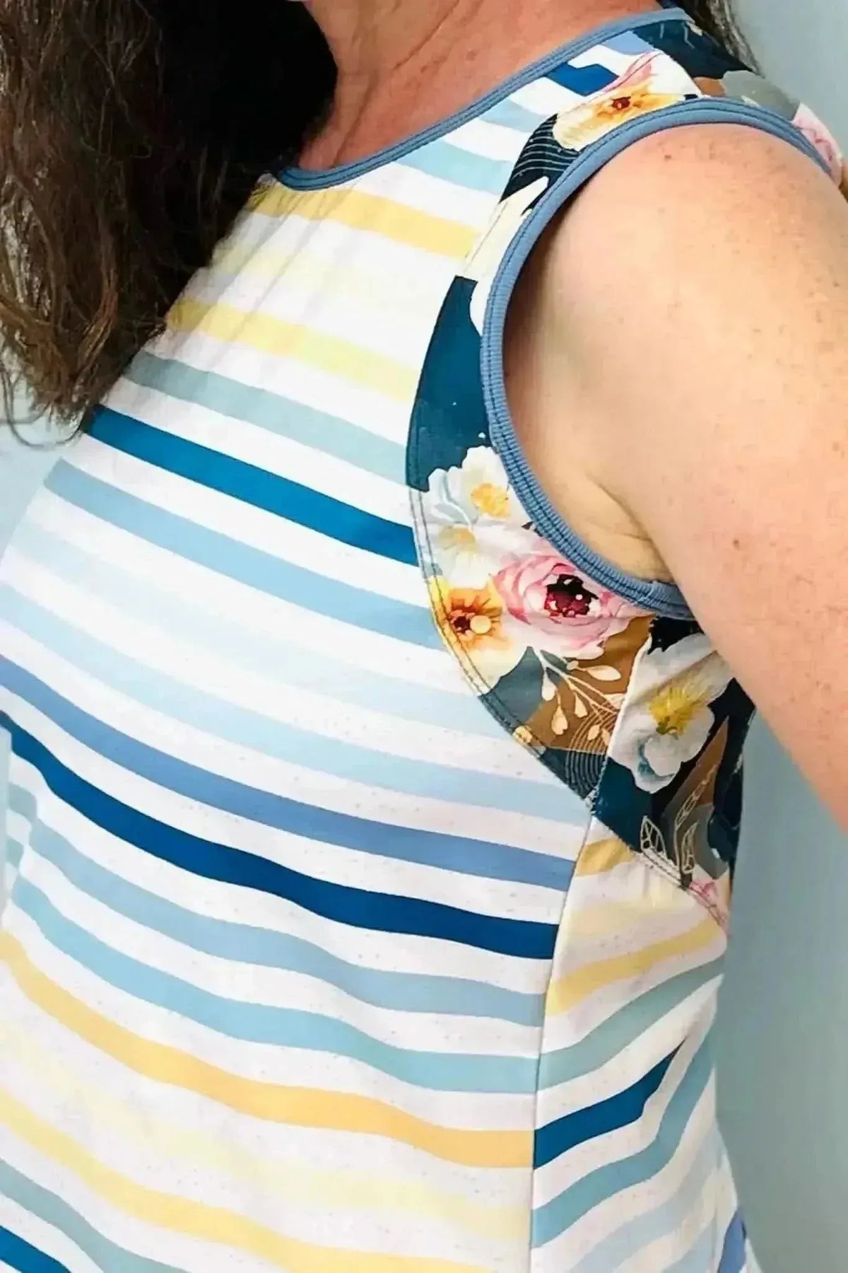 Striped fabric with seaside stripes and floral accents in blue, yellow, and white.