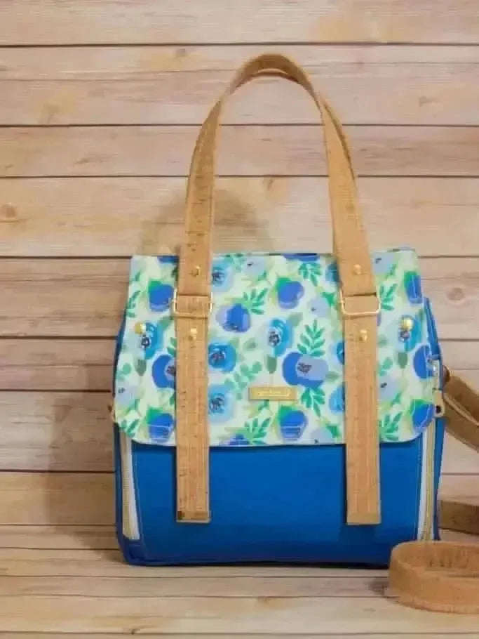 Blue buttercups floral fabric with white and green leaves on a blue background.