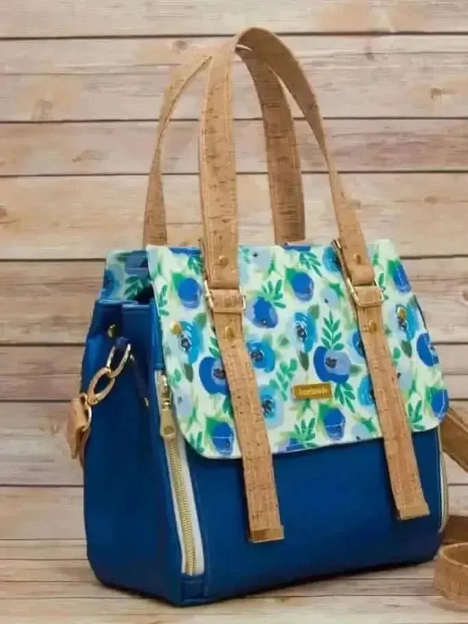 Blue buttercups floral print fabric with white background and green leaves.