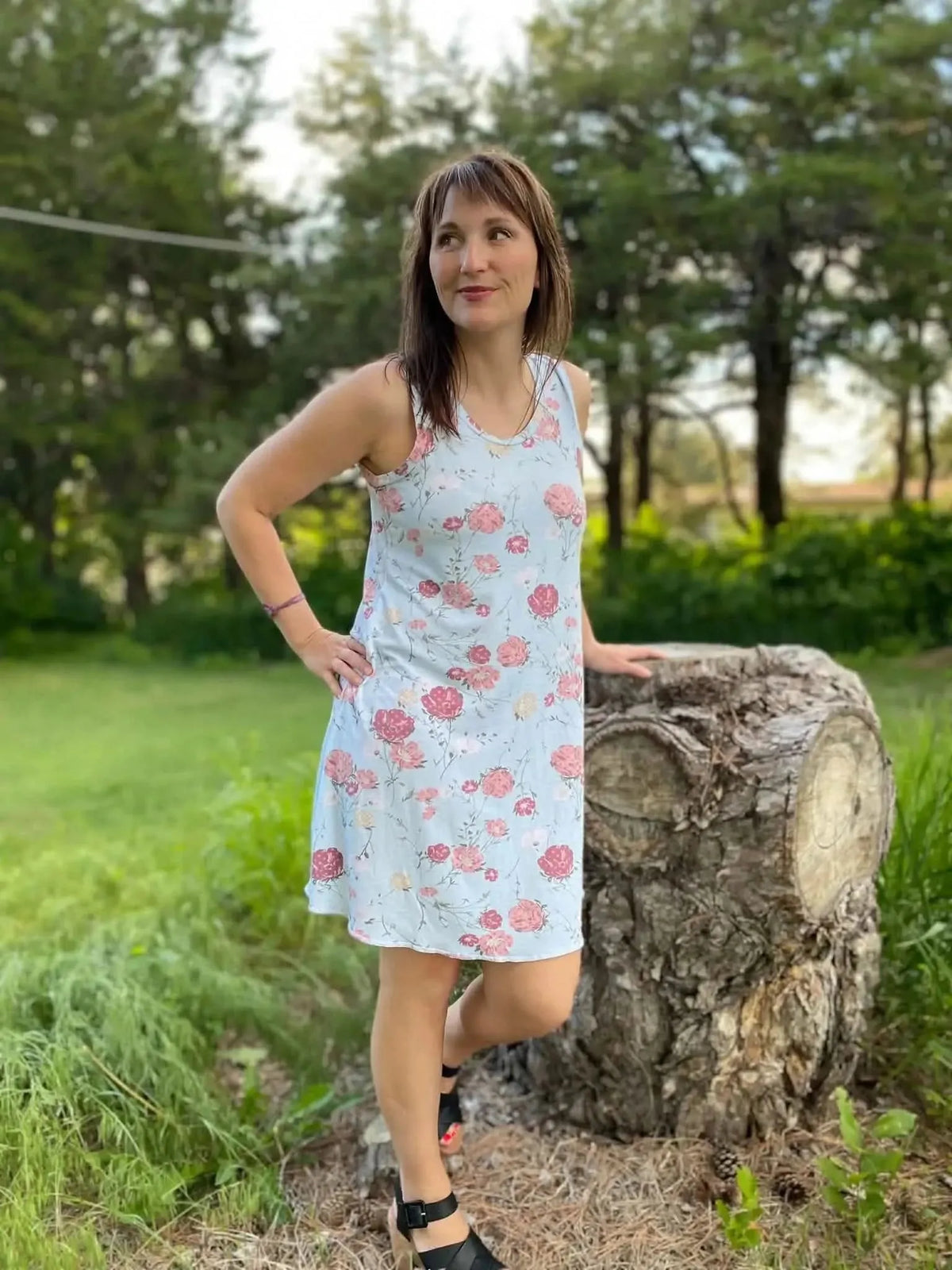 Light blue fabric with pink floral print, shown as a sleeveless knee-length dress.