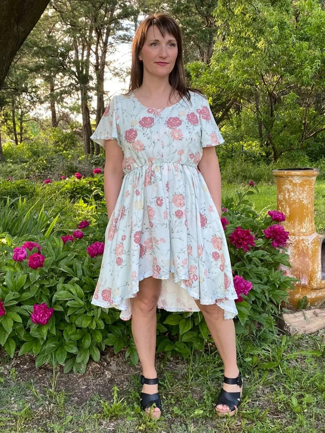 Floral print fabric with modern pink blooms on a light background.