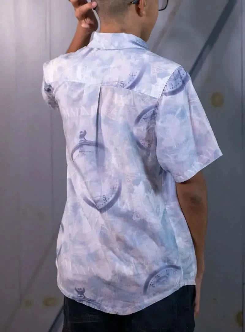 A person from behind wears a blue shirt with a clock and Roman numeral pattern.