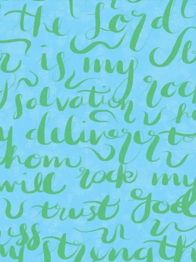 A light blue fabric with green script lettering.