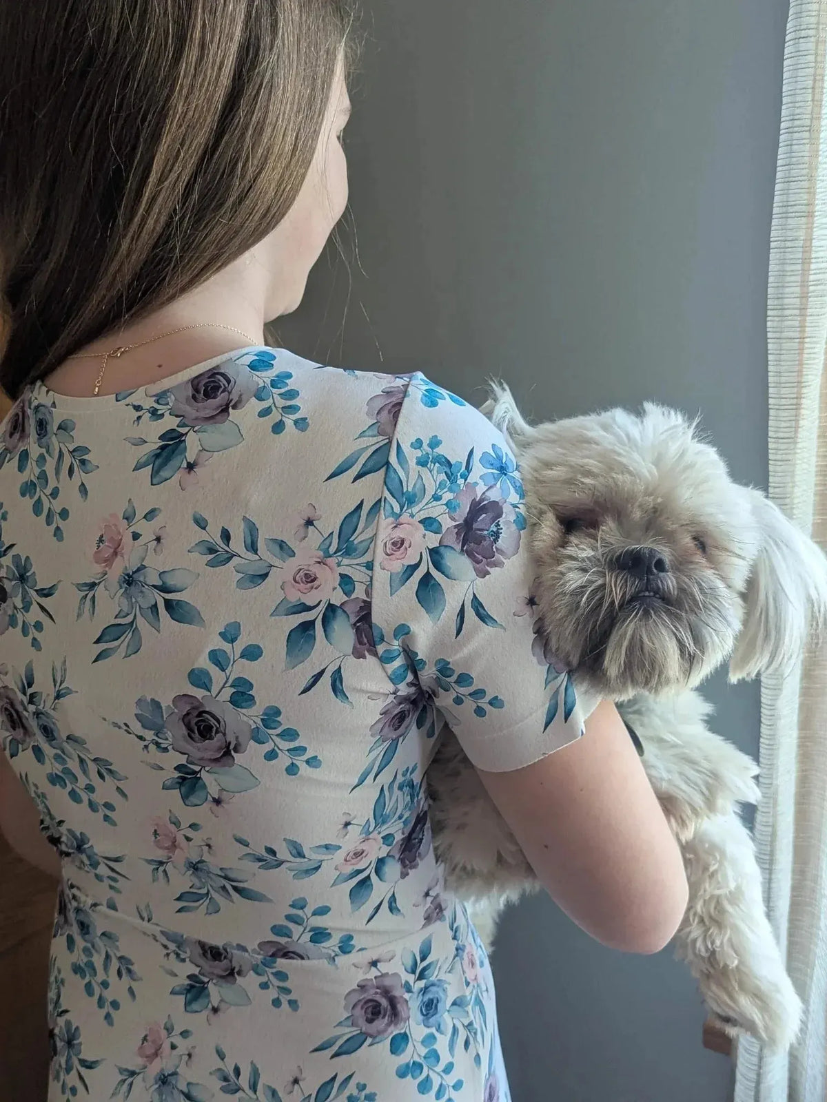 Blue watercolor floral print fabric with soft pink and purple flowers on white background.