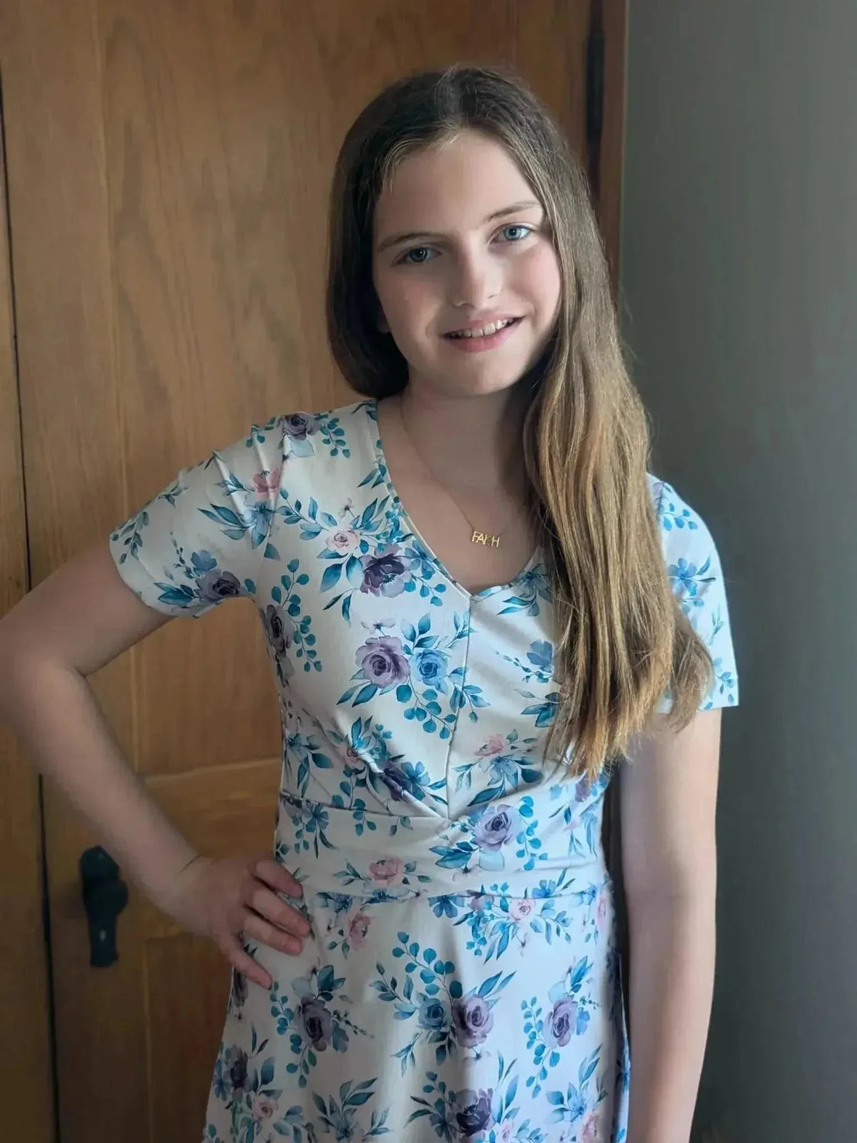 Blue watercolor floral print fabric with soft purple and white flowers.