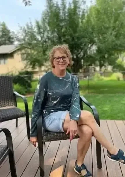 Green fabric with celestial sky fantasy print featuring moons and stars.